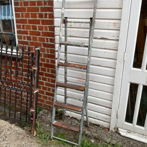 Vintage metal step ladder with wooden steps, rustic farmhouse style.