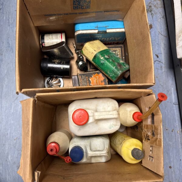 Vintage motoring fluids and tins, a collection of automotive collectibles.