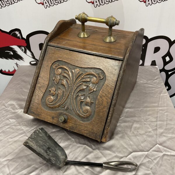 Vintage oak coal scuttle with brass handle and carved detail.