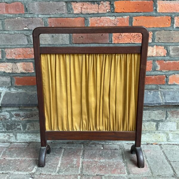 Vintage oak fire screen with gold fabric panel for fireplace.