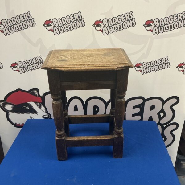 Vintage oak footstool with turned legs, rustic farmhouse style.