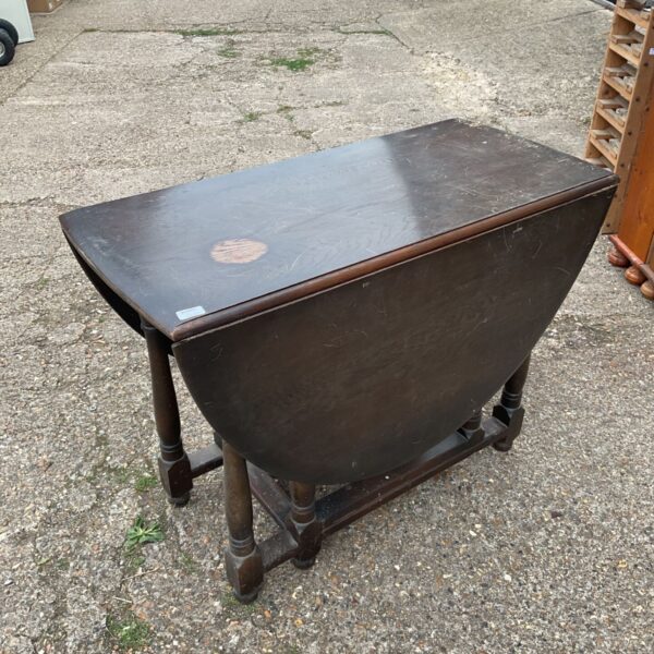 Vintage oak gate leg table with drop leaf design.