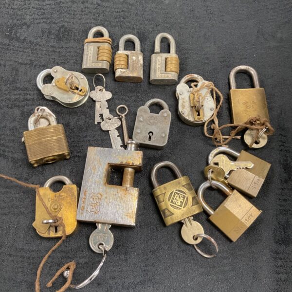 Vintage padlock collection with keys, antique brass locks.