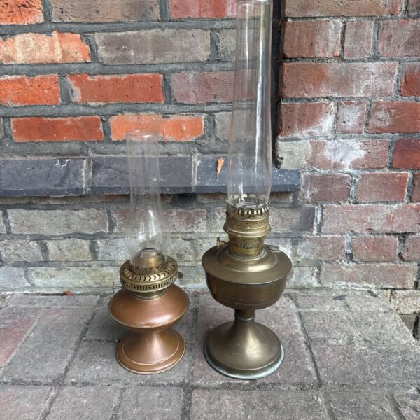 Pair of vintage paraffin lamps with brass bases and glass shades.