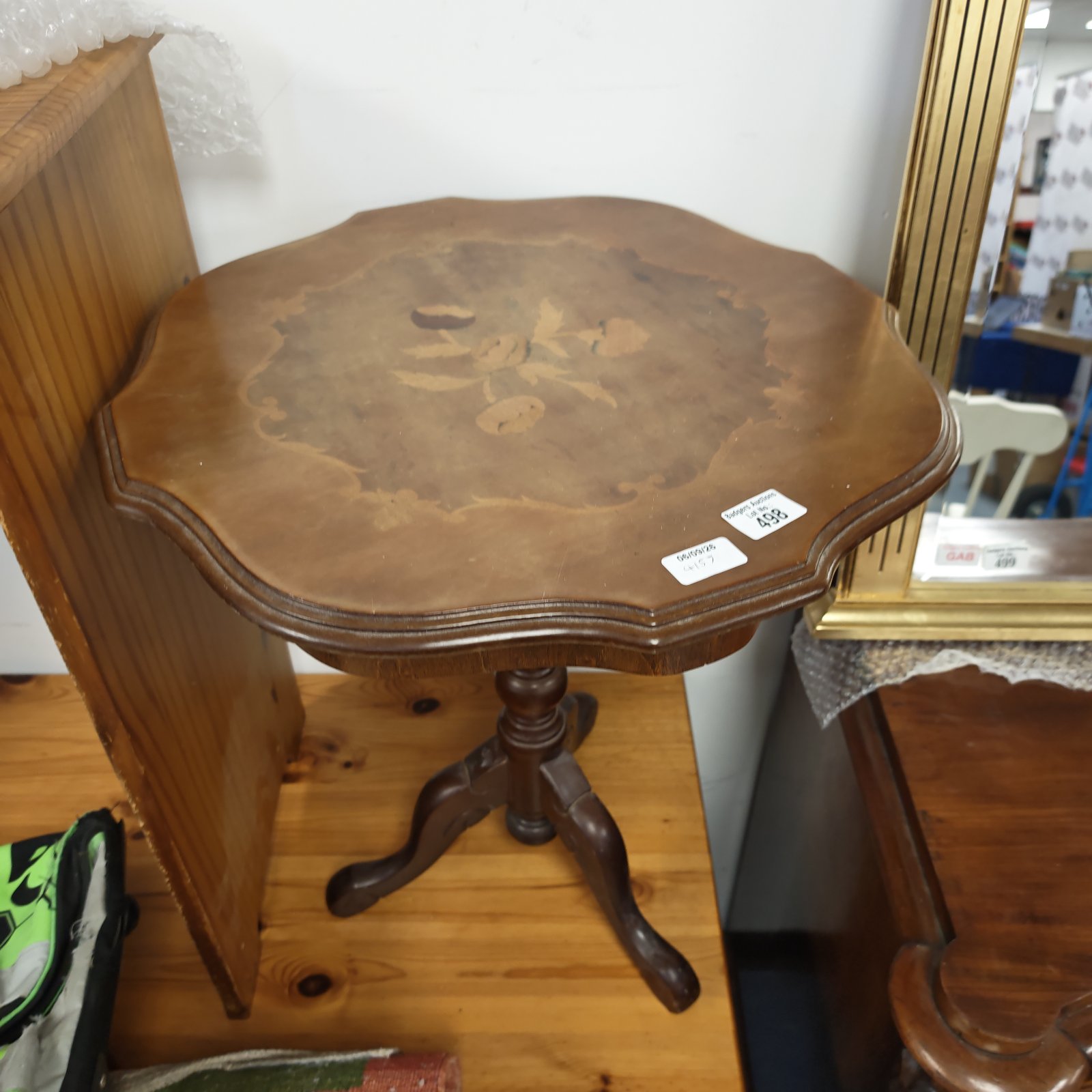 Vintage pedestal table with floral marquetry inlay, a charming occasional table.