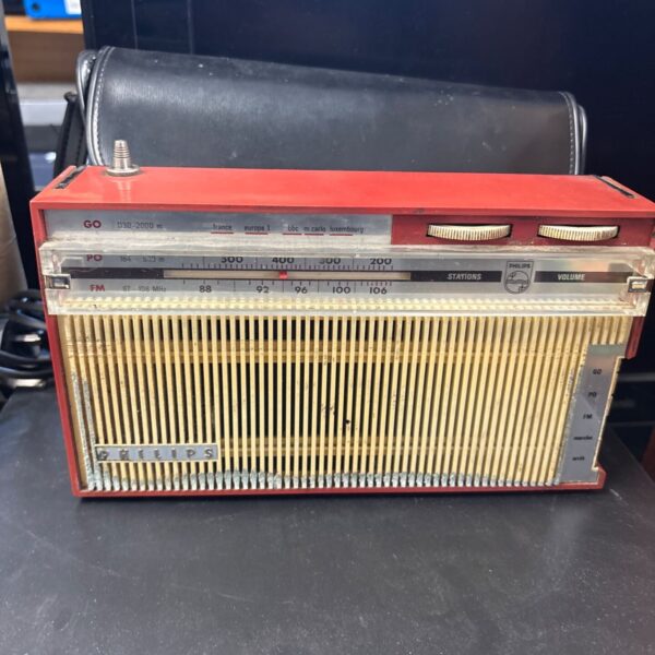 Vintage Phillips transistor radio with tuning dial and frequency markings.