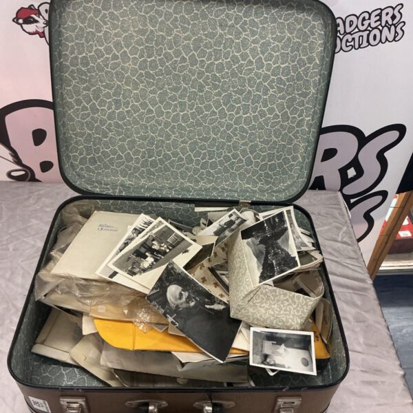 Suitcase filled with a vintage photograph collection, black and white photos.