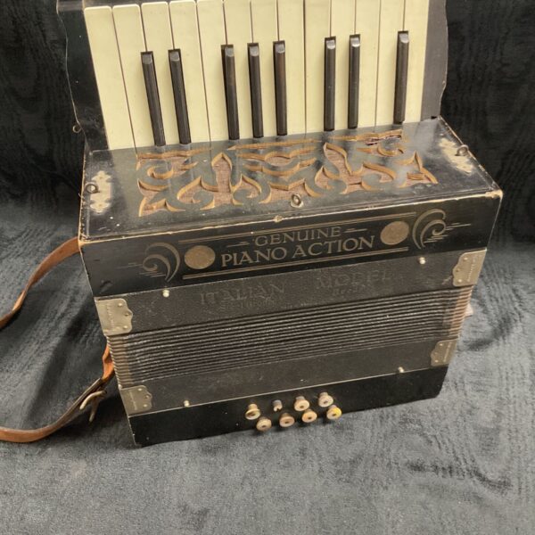 Front view of a vintage Genuine Piano Action accordion.