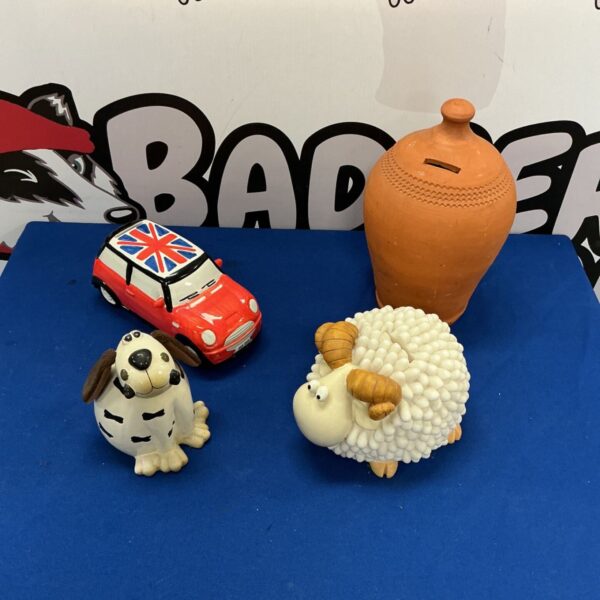 Vintage ceramic piggy bank collection featuring animal designs.