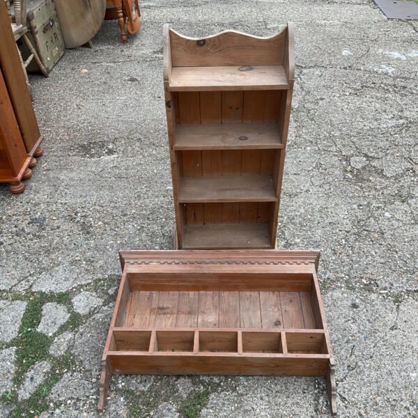 Vintage pine bookcase with three shelves and a cupboard door.