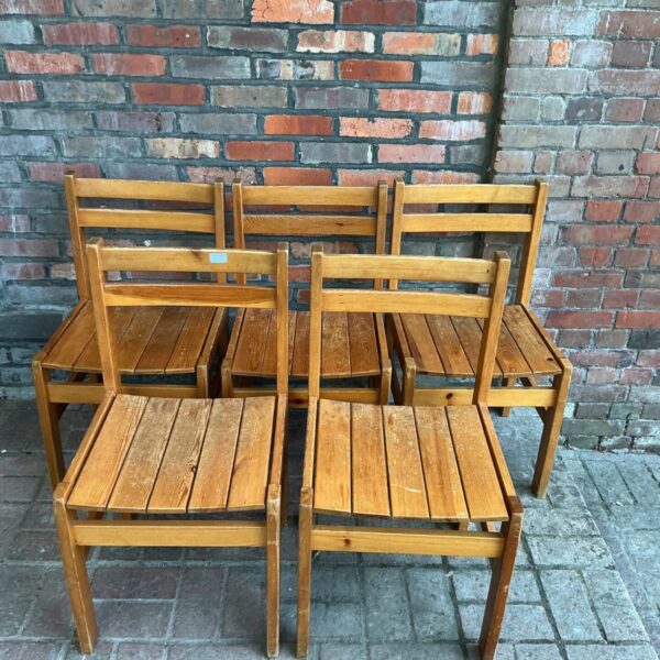 Lot of five vintage pine chairs with slatted backs.