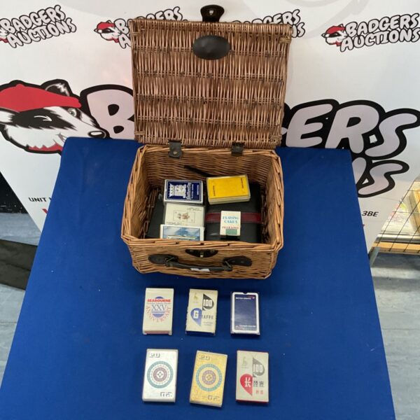 Vintage basket filled with packs of playing cards for collectors.