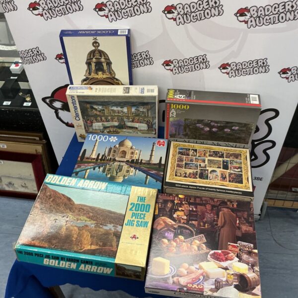 Vintage jigsaw puzzle collection including Clock and Arrow Games puzzles.