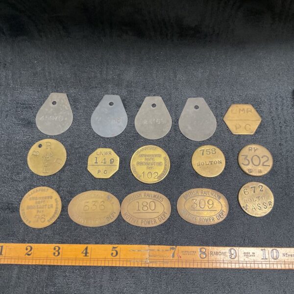 Collection of vintage railway pay tokens, close-up view.