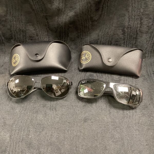 Vintage Ray Ban sunglasses with cases, classic aviator style.