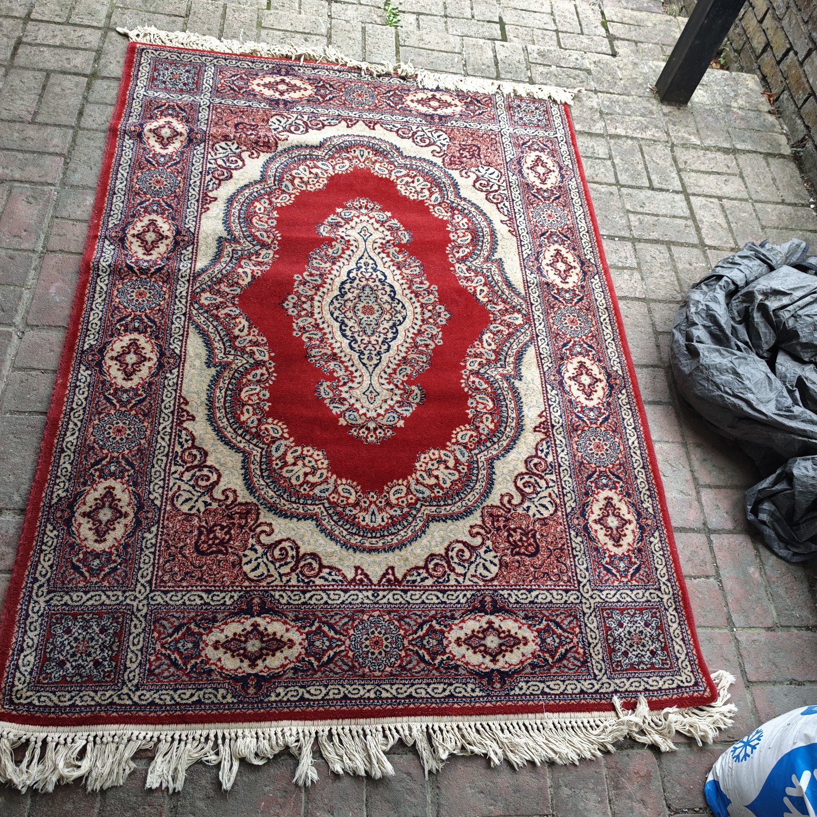 Vintage red rug with a geometric pattern, ideal for home decor.