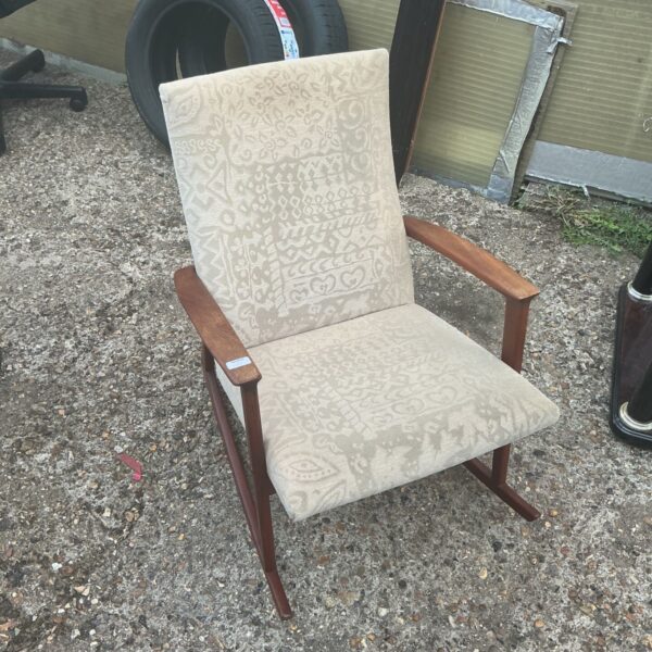 Vintage patterned rocking chair with wooden frame.