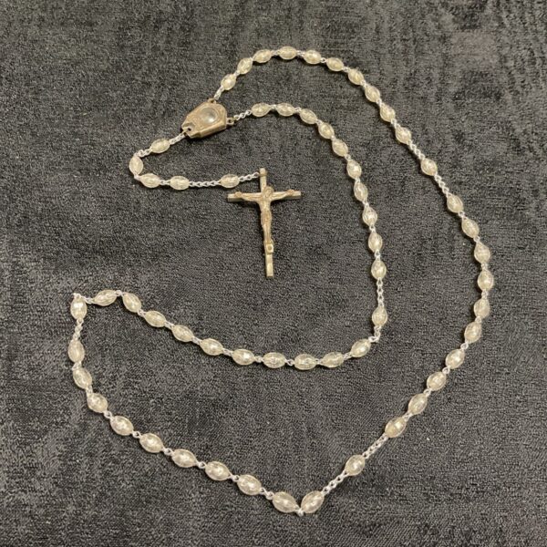 Vintage rosary necklace with a crucifix pendant, detailed beadwork.