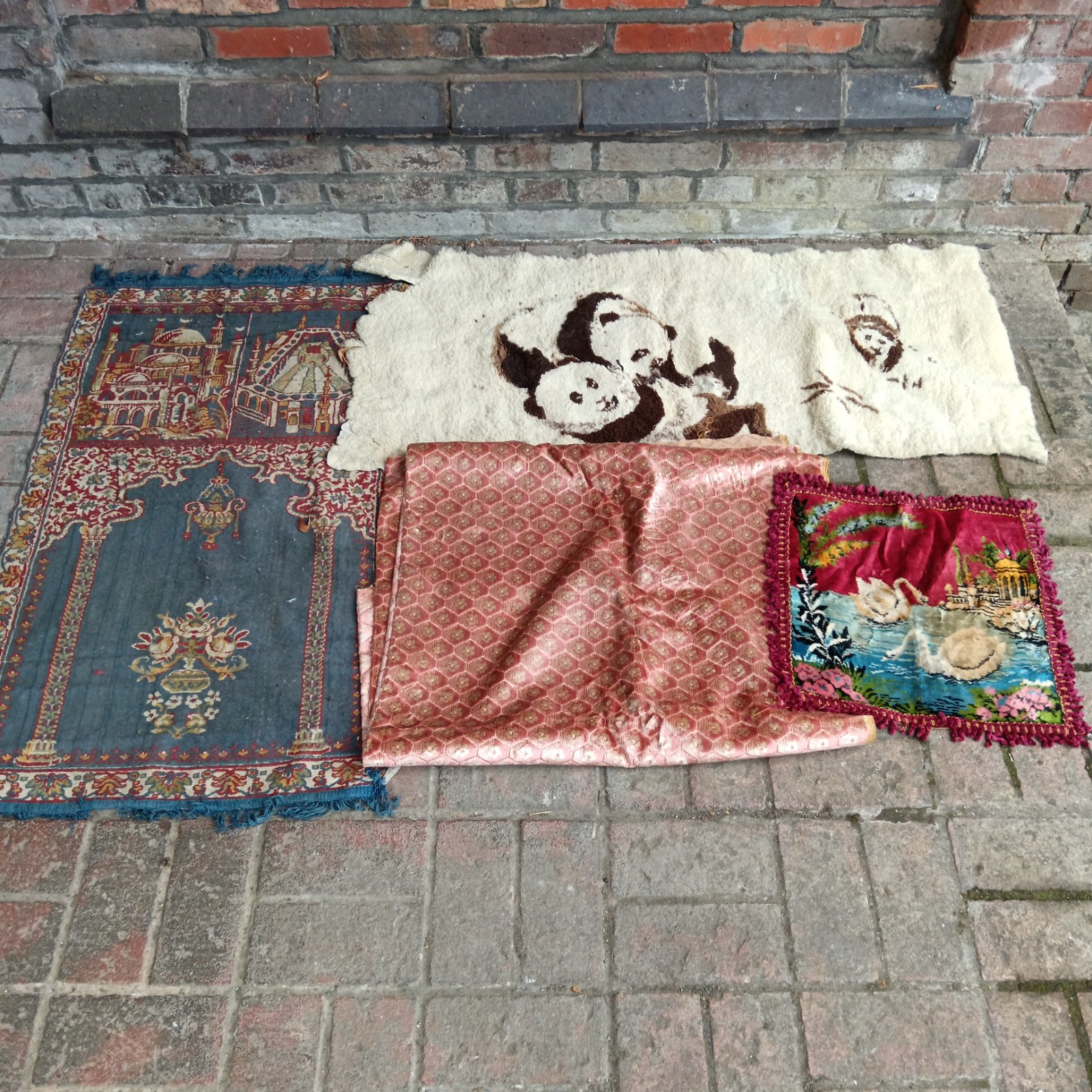 Vintage rugs selection including a prayer mat and panda rug.