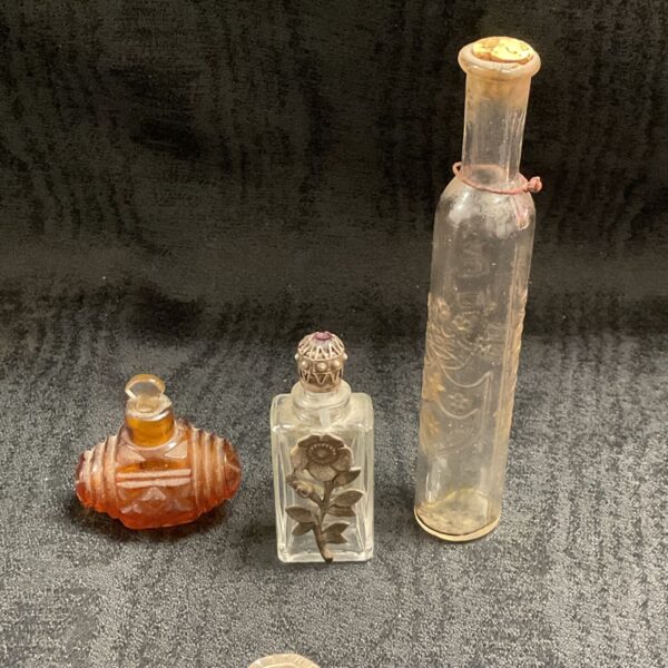 Amber vintage scent bottle with decorative stopper.