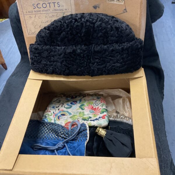 Vintage box containing a black Scotts hat and floral purses.