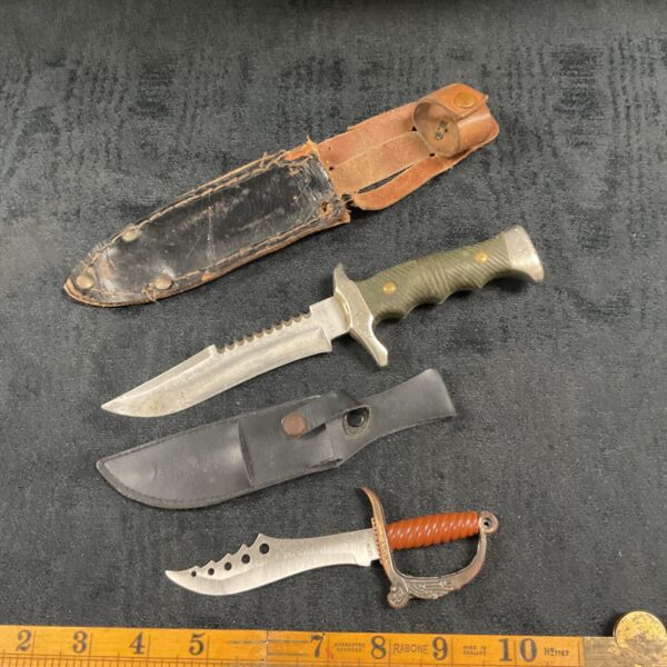 Vintage sheath knife pair with leather sheaths, collectible blades.