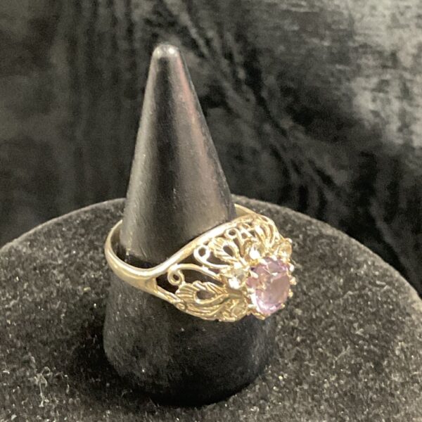 Vintage silver ring with amethyst gemstone and filigree band.