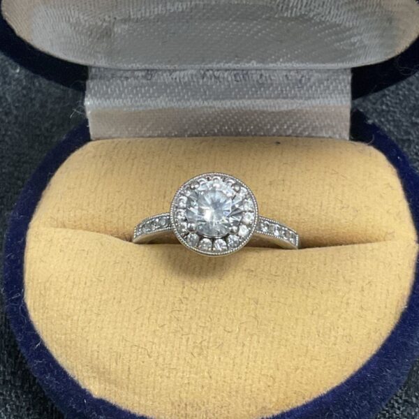 Vintage silver halo engagement ring with clear centre stone.