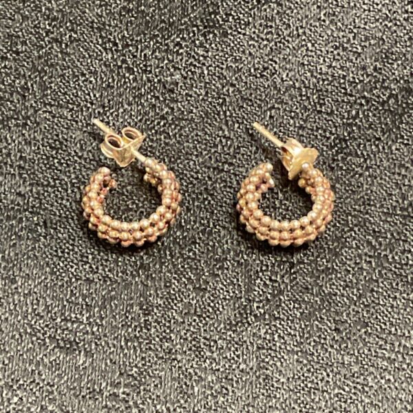 Close-up of vintage silver hoop stud earrings by Stefani St Jaques.