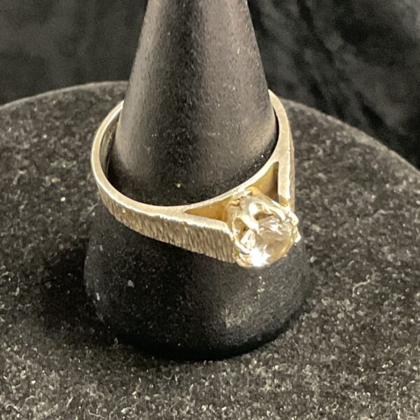 Vintage sterling silver solitaire ring with a clear stone.