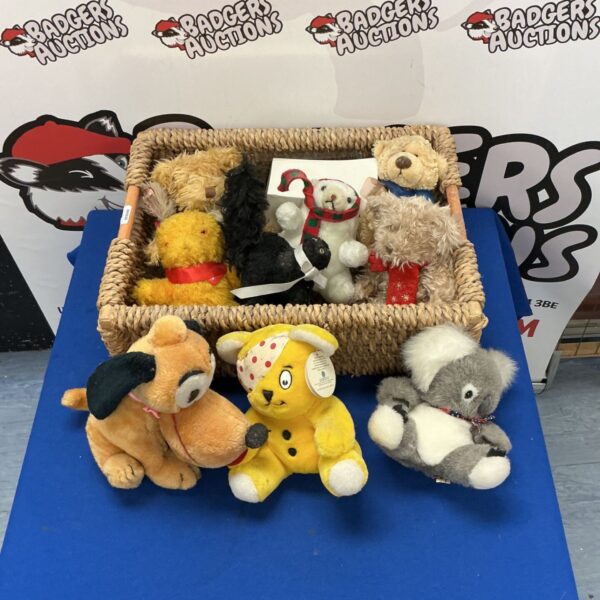 Vintage soft toy basket featuring Disney Pluto and other plush toys.