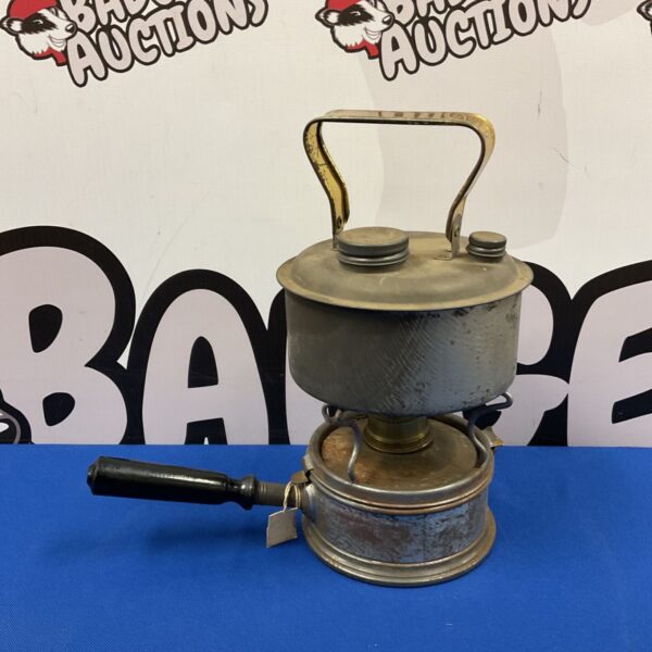 Vintage spirit stove and enamel kettle, a collectible camping set.