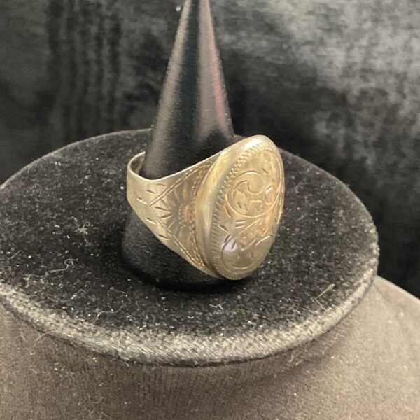 Vintage sterling silver ring with detailed floral design.