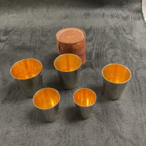 Set of five vintage tan leather stirrup shot cups.