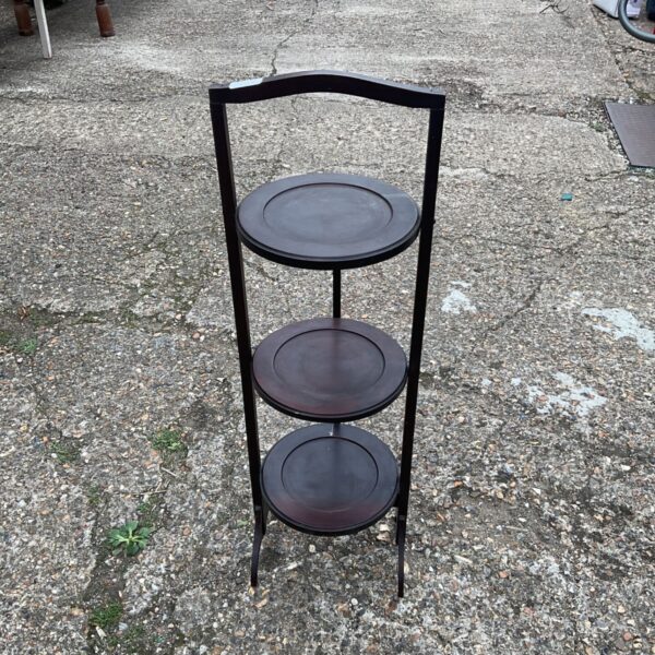 Vintage three tier pot stand for displaying collectibles.