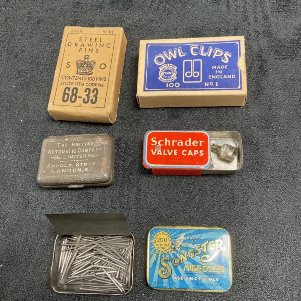 Group of vintage tins with original contents, collectible ephemera.