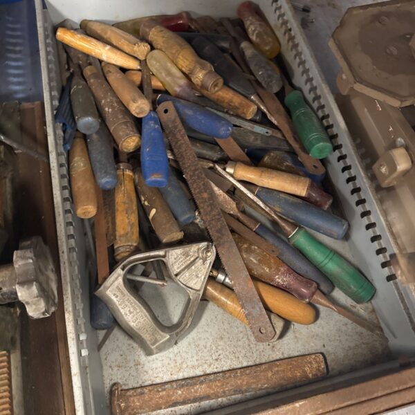 Vintage tool lot in metal drawer, antique hand tools collection.