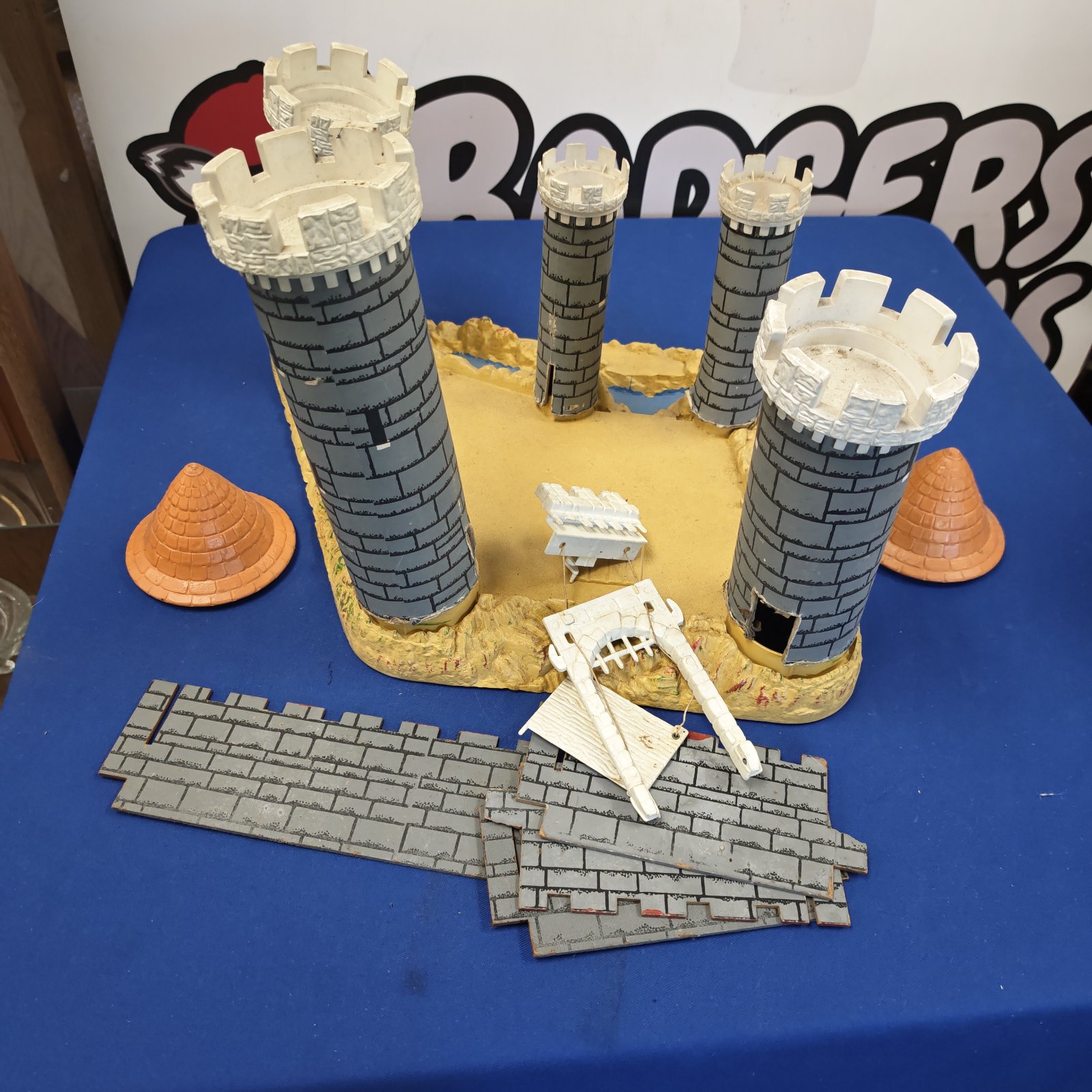 Vintage plastic toy castle with a blue moat base.