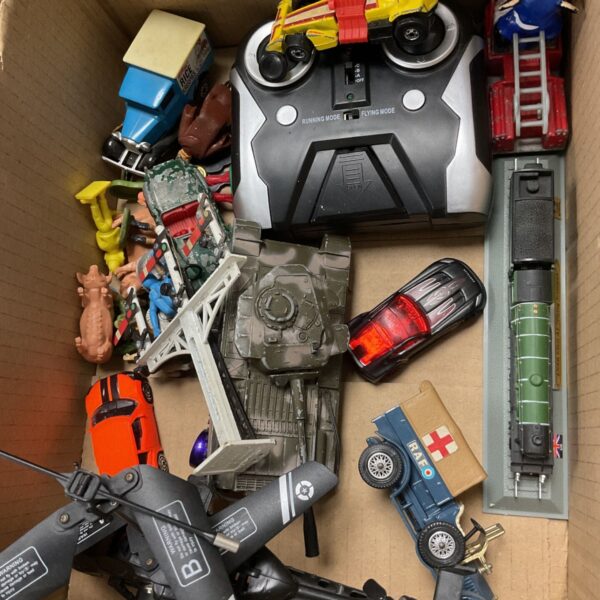 Vintage toy lot featuring a Corgi tank and RC helicopter.