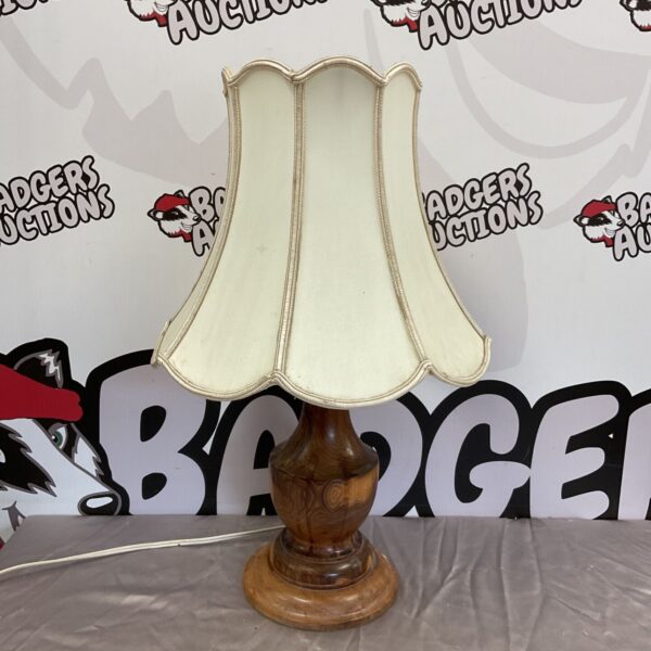 Vintage turned wood table lamp with cream shade.