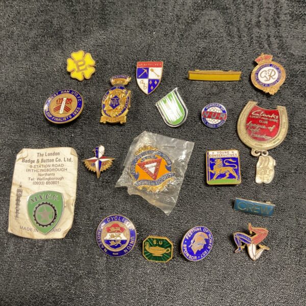 Vintage enamel pin badges collection, including union badges.