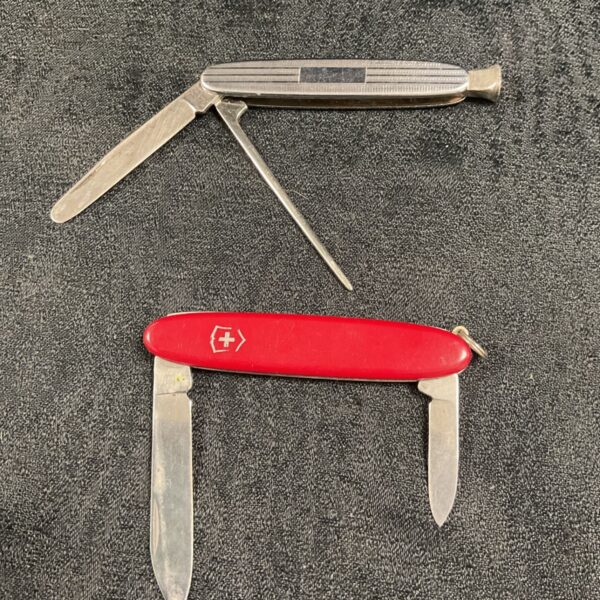 Vintage Victorinox pocket knife with red handle and multiple blades.