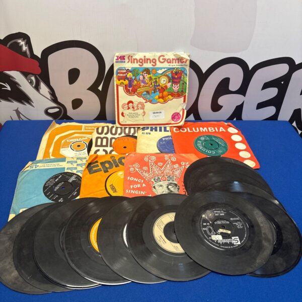 Mixed bundle of vintage 7” vinyl records for collectors.