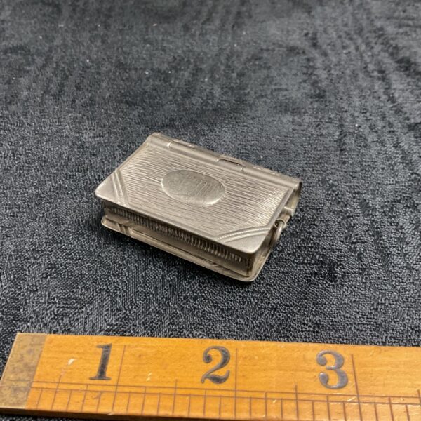 Vintage whitemetal vesta case with floral embossing.
