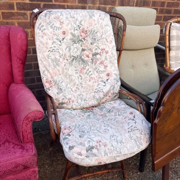 Vintage wicker armchair with floral upholstery, a charming retro seating option.
