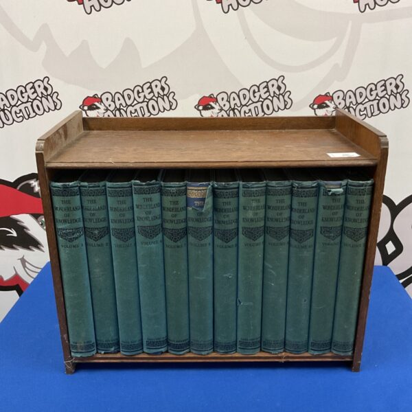 Vintage oak bookcase displaying a set of Wonderland of Knowledge books.
