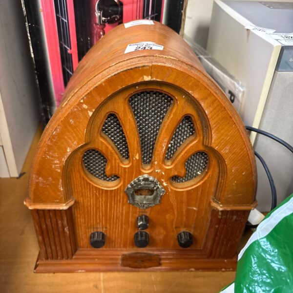 Vintage woodgrain radio with fabric speaker grill.