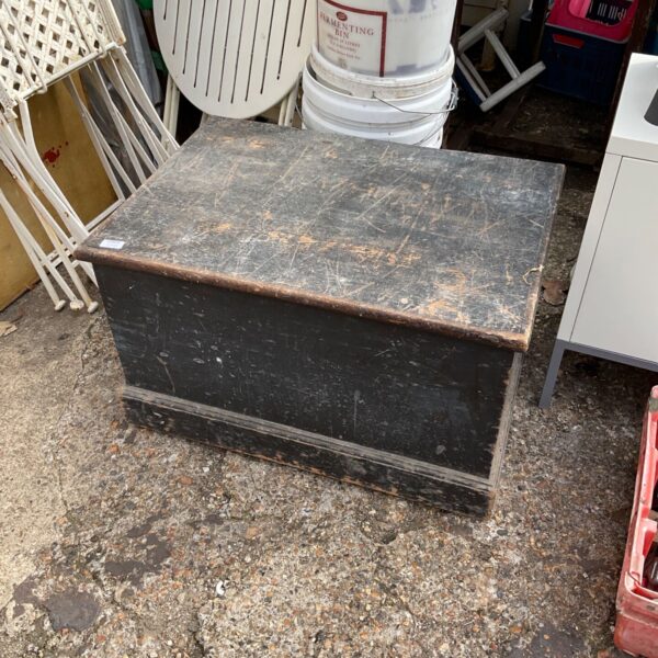 Vintage wooden chest with a lift-top lid, ideal for storage.