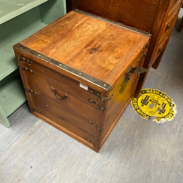 Vintage wooden chest with metal clasp, ideal for storage.