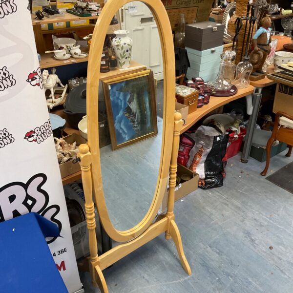Vintage wooden framed dressing mirror with oval reflection.